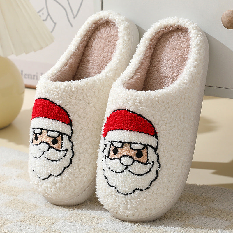 Chaussons de Noël en coton avec un mignon Père Noël en cartoon pour femmes et hommes, chaussures d'hiver chaudes et duveteuses pour couples.